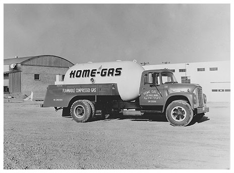 A black and white photo of one of Arrow Tank's original transport trucks, printed with the name "Home-Gas."