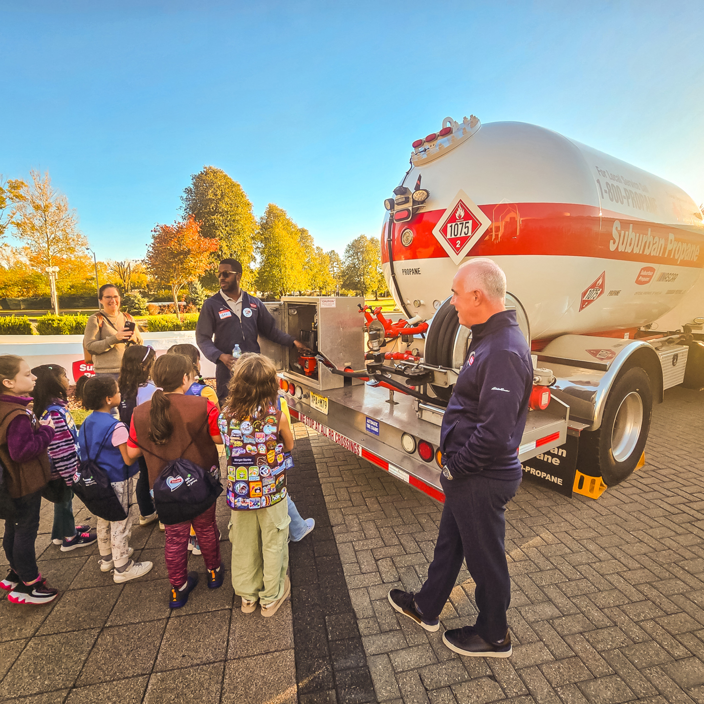 Suburban CEO Michael Stivala looks on while a Suburban truck driver speaks to the Girl Scout troop about propane bobtails at the Trucks Are for Girls event