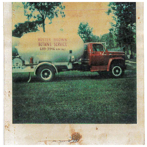 An old photo of a red truck with a white bobtail that reads "Buster Brown Butane Service"