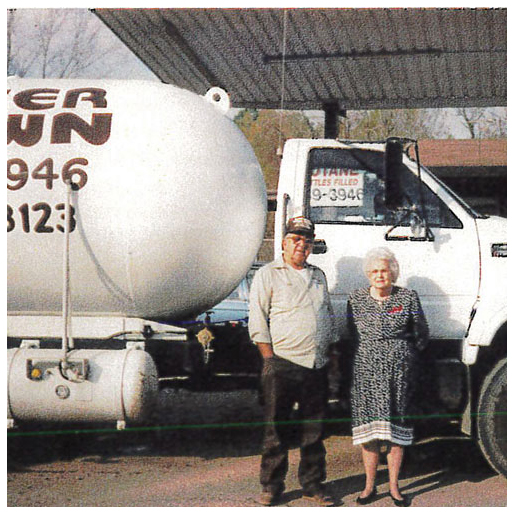 Lois and Buster Brown stand in front of a company bobtail