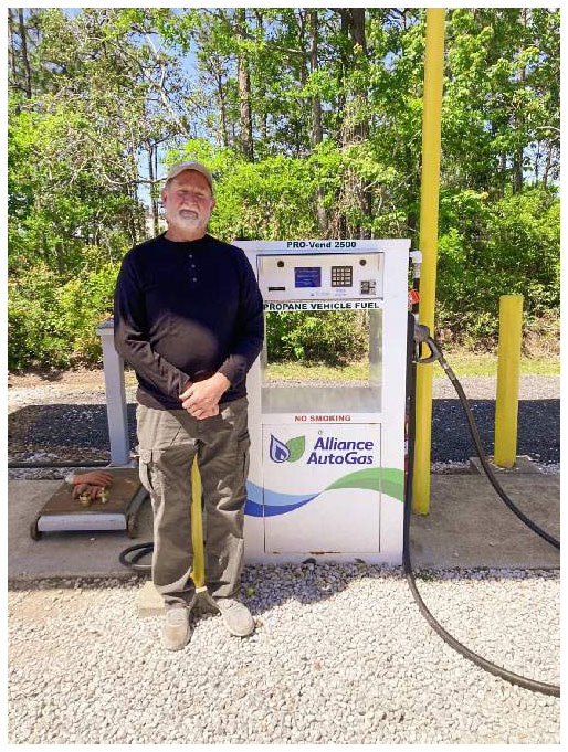 Bryan Haynes stands in front of an Alliance AutoGas propane vehicle self-fueling station.