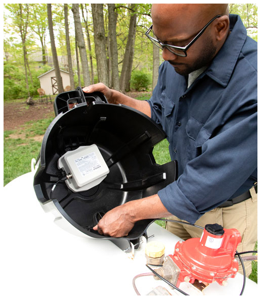 A man works on a propane remote tank monitor