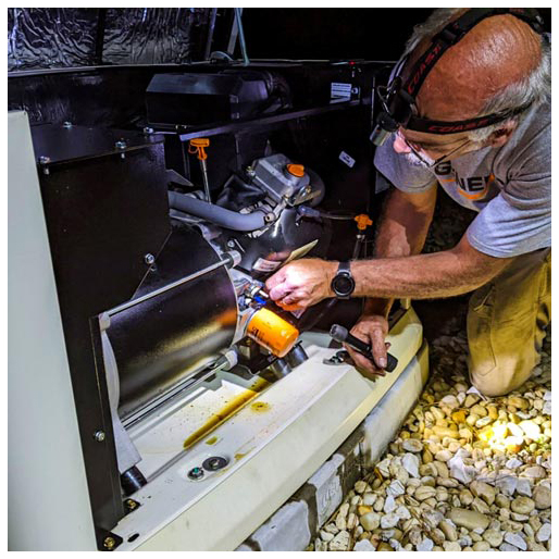 A Generac team member services a power generator