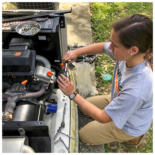 A Generac team member services a power generator