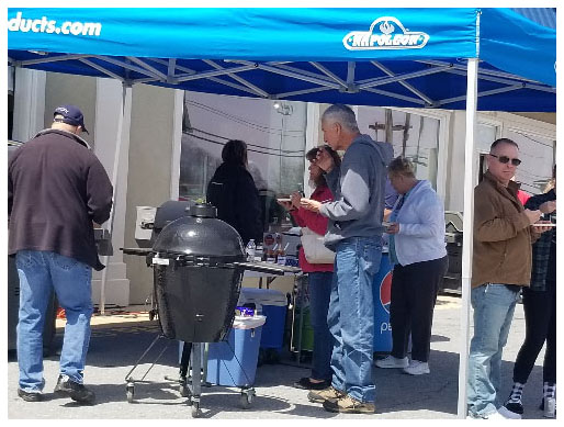 Street fair attendees enjoy food prepared at the Tevis Propane booth.