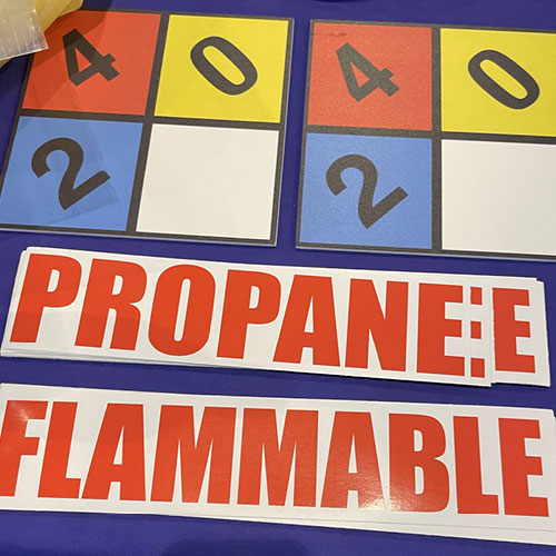 A propane sign warns of the container's flammable contents.