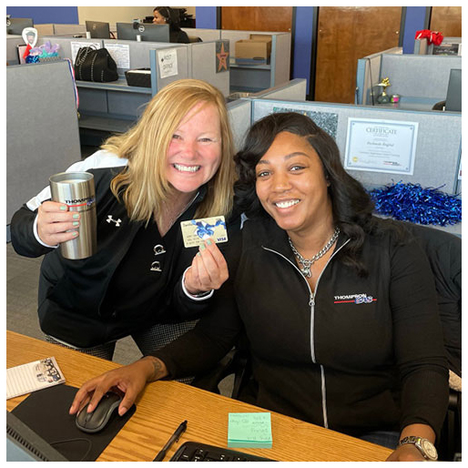 Two female employees celebrate with perks earned during training exercises