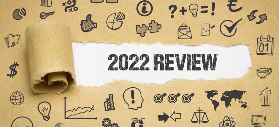 Brown paper is torn back to reveal "2022 Review" on the paper underneath