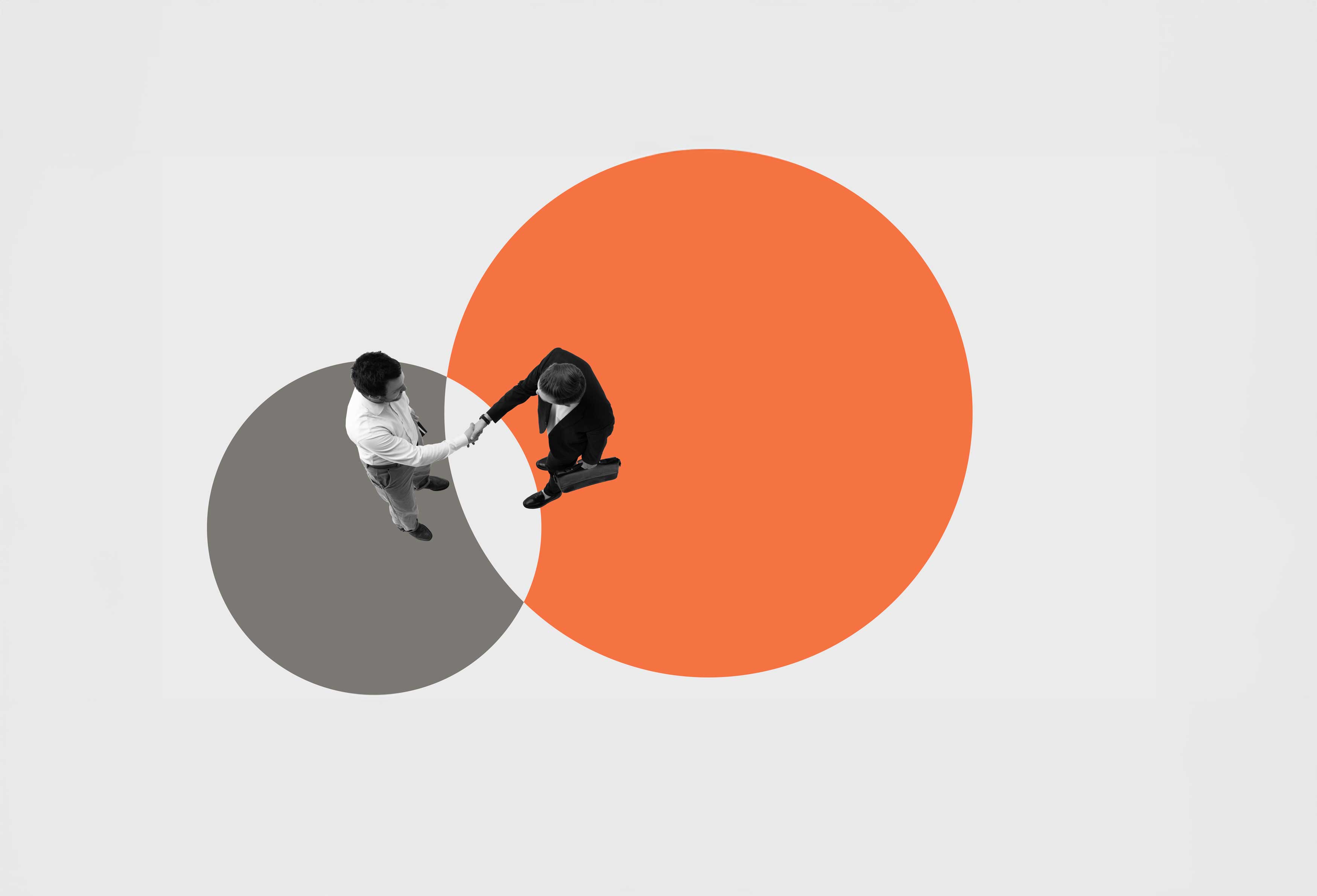 Asset Deal vs. Stock Deal in Business Sales shown by two men shaking hands and meeting in the middle