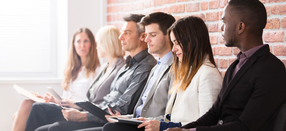 Six job candidates sitting in a row