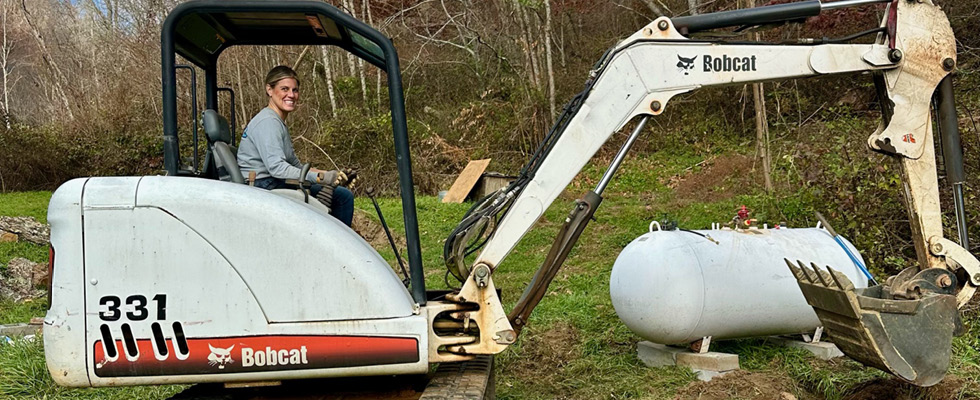 Reagan Bonnette of Stringer Oil & LP Gas operates a Bobcat excavator in assistance to western North Carolina residents.