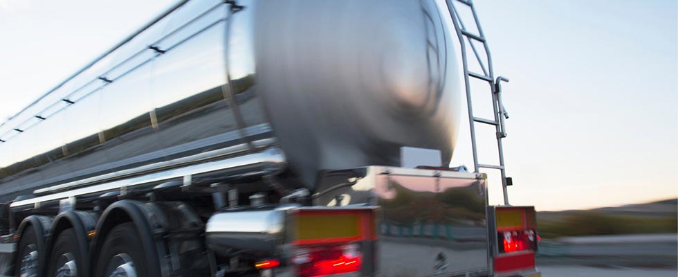 A propane semi-truck hauls propane along a highway.