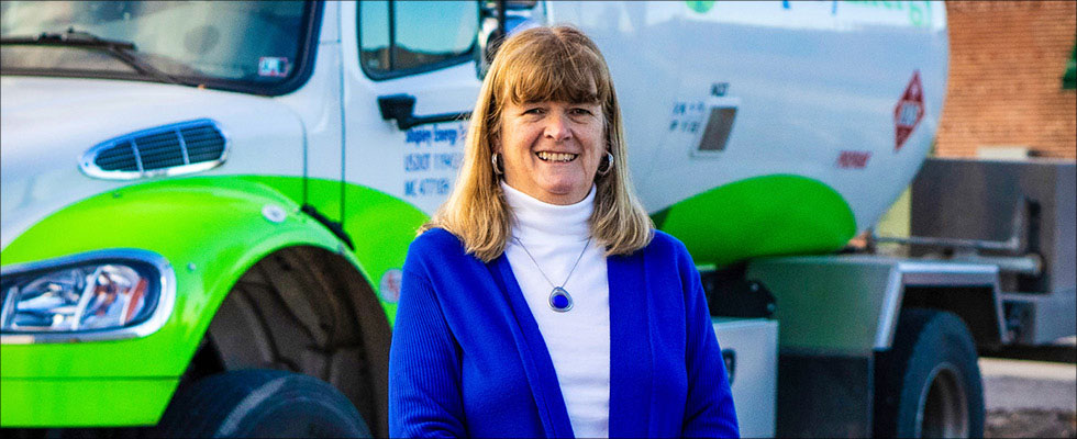 Beth Donovan smiling in front of a propane truck