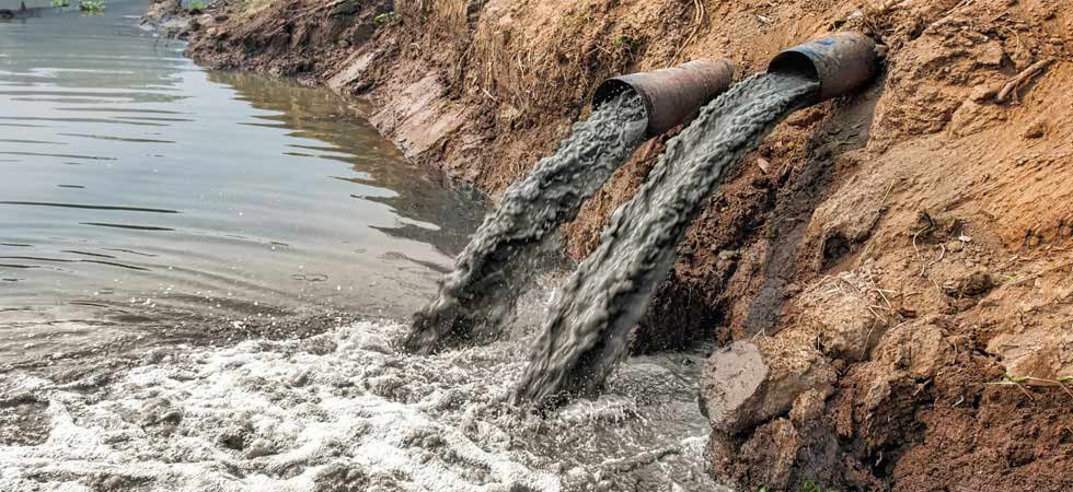 Pollution runoff is emptied by pipes into natural water