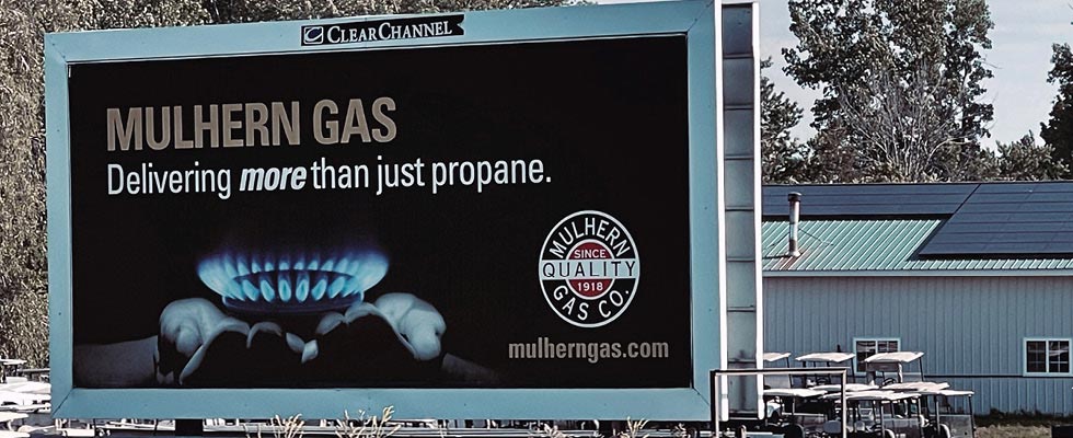 A billboard hosting a propane ad that says Delivering more than just propane fro Mulhern Gas