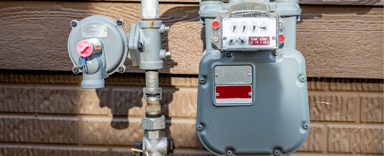 A propane meter is depicted against the side of a house.