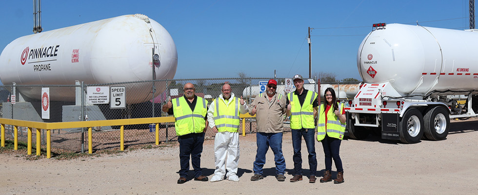 Pinnacle Propane team members stand in front of propane bobtails.