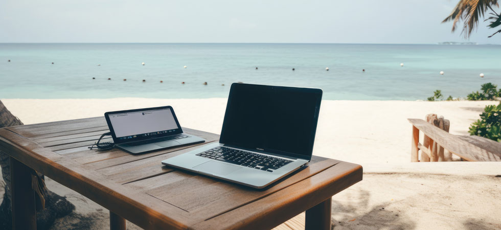 A picture of a laptop is featured with a backdrop of a beach.