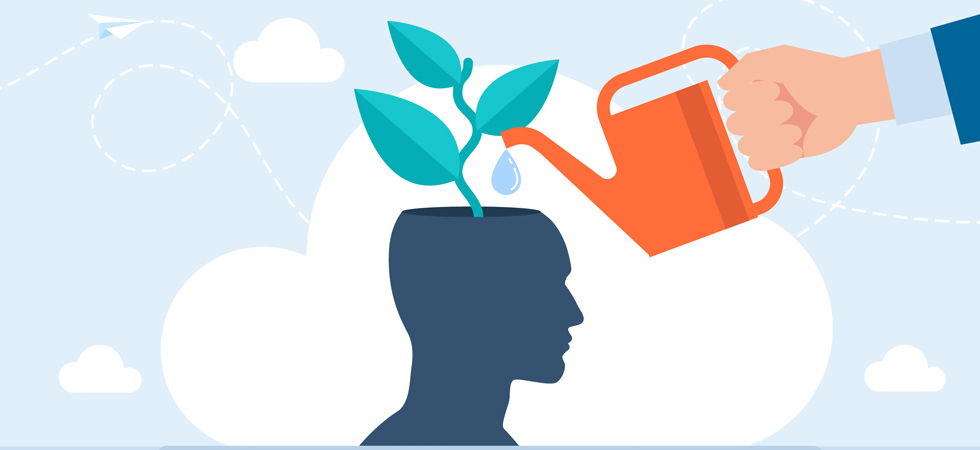 A hand using a watering can to water a brain just like unexpected lessons learned this past year