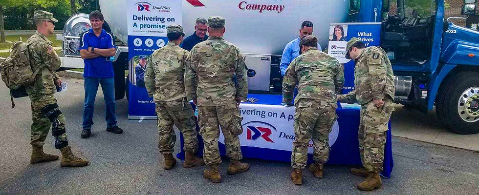 Dead River Company employees participate in a veteran recruitment event in front of a company truck