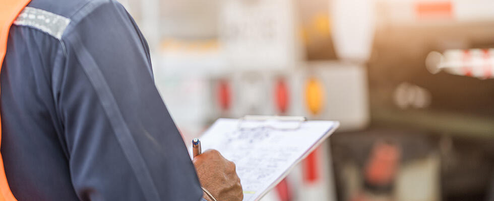 A person writing on a clipboard