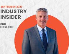 A graphic that says "September 2023 Industry Insider Phil Horlock" with a headshot of Horlock in a dark gray suit in front of an orange circle frame