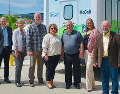 A photo of several people involved in the implementation of propane autogas in Prairie Hills fleets are pictured in front of a public bus.