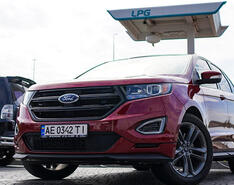 An autogas-fueled Ukrainian vehicle is depicted parked in front of an LPG fueling station.