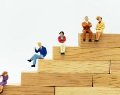 A staircase with figurines depicts emergency succession and succession planning.