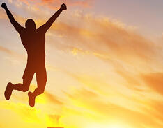 This image is an example of someone jumping for joy due to joy-focused propane management