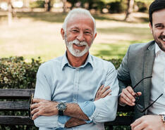 An older man poses with a young man, presumably father and son, showcasing bringing family into your propane business.