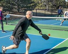 Two couples play tennis with each other, an example of how you might use free time.