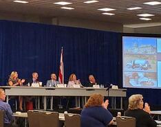 The 2022-2023 NPGA officers sit in a panel onstage at the 2023 summer board of directors meeting