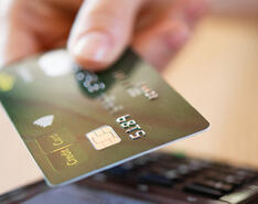 Payment processing strategy is represented by a photo of a customer using a card.