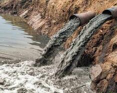 Pollution runoff is emptied by pipes into natural water
