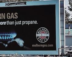A billboard hosting a propane ad that says Delivering more than just propane fro Mulhern Gas