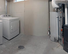 A picture shows a basement with a heating unit in place.