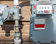 A propane meter is depicted against the side of a house.