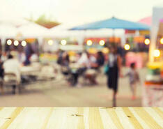 An out of focus image of people at a block party or farmer's market outdoor event