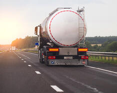 A propane truck driving on a highway