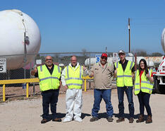 Pinnacle Propane team members stand in front of propane bobtails.