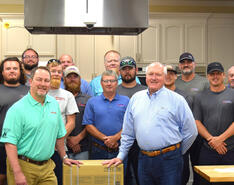 The Conger Gas team poses on the set of a video shoot.