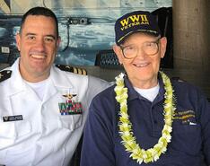 Jason Grower smiles for the camera alongside a World War II veteran
