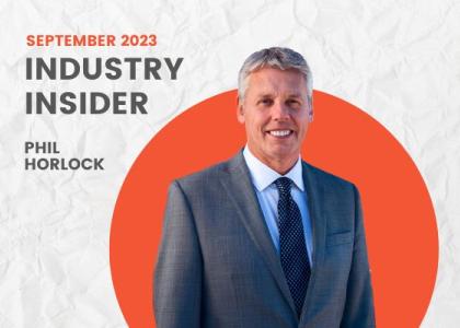 A graphic that says "September 2023 Industry Insider Phil Horlock" with a headshot of Horlock in a dark gray suit in front of an orange circle frame