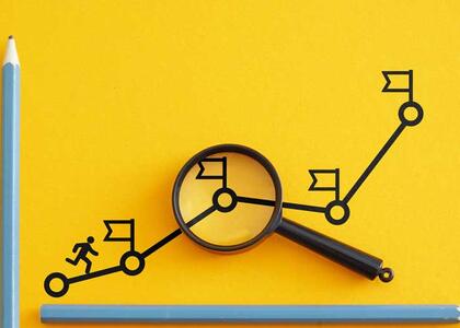 A stick figure runs up a line graph with flags marking different goals met