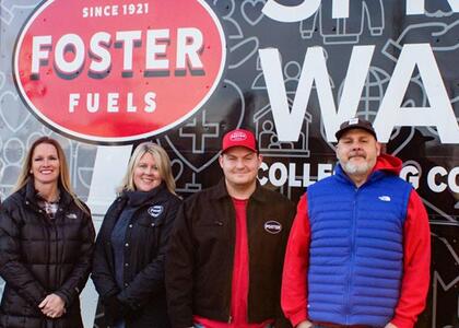 Representatives from Foster Fuels are pictured in front of their community service truck.