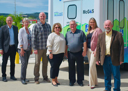 A photo of several people involved in the implementation of propane autogas in Prairie Hills fleets are pictured in front of a public bus.