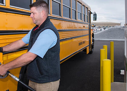 A man filling up a bus with autogas