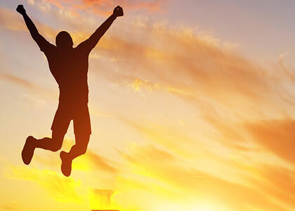 This image is an example of someone jumping for joy due to joy-focused propane management