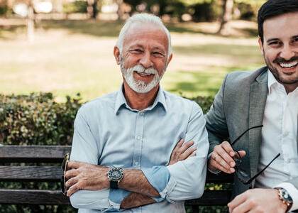 An older man poses with a young man, presumably father and son, showcasing bringing family into your propane business.